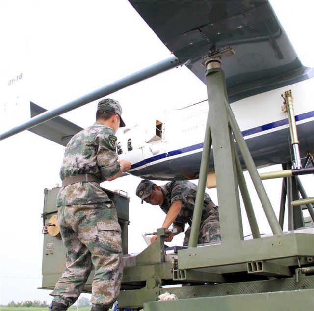 Soldiers perform pre-mission checks on the unmanned aerial vehicle (UAV) carrying communication relay system prior to a training exercise. 