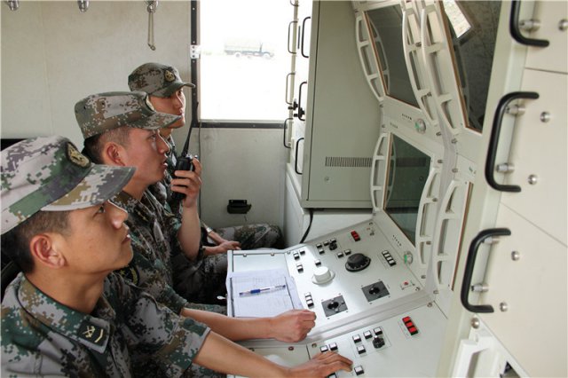Soldiers operate an unmanned aerial vehicles (UAV) carrying communication relay system at a ground station during a training exercise