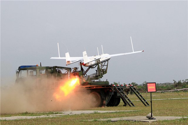 oldiers launch an unmanned aerial vehicle (UAV) carrying communication relay system during a training exercise