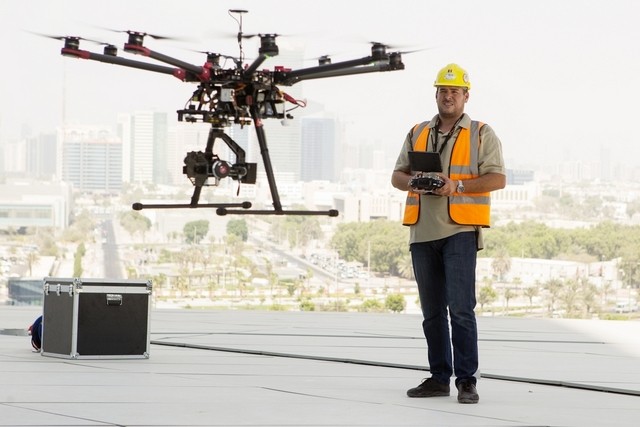 Adriah Ninteoar, the pilot for Technometer Middle East, uses drone technology with an attached thermal camera to inspect and scan the exterior of Etihad Towers in Abu D habi for tiny holes where cold air might escape