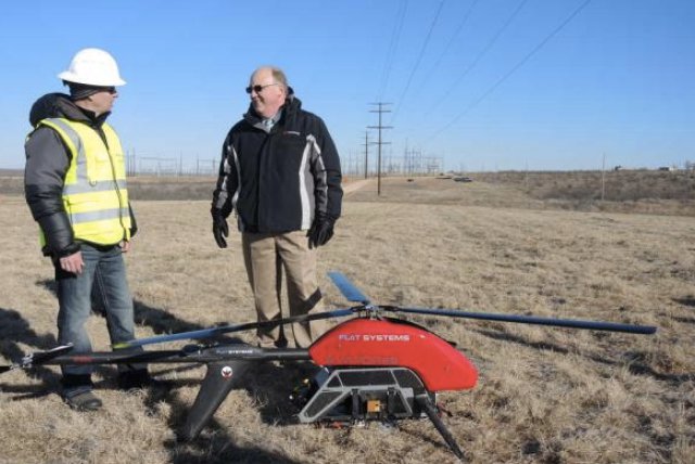 Chris Vallier, left, CEO of Flot Systems, shows the Vapor 55 drone to David Hudson, president and CEO of Southwestern Public Service, an Xcel subsidiary.