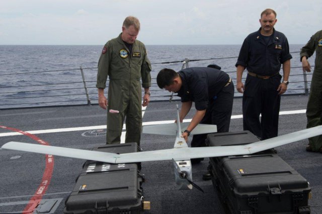 Ensign N. Sanchez shows Commander, Carrier Strike Group 4 Rear Adm. Richard Butler a Puma II unmanned aircraft system aboard the guided-missile destroyer USS Gonzalez. (U.S. Navy Photo by Mass Communications Specialist 2nd Class D. C. Ortega/Released)
